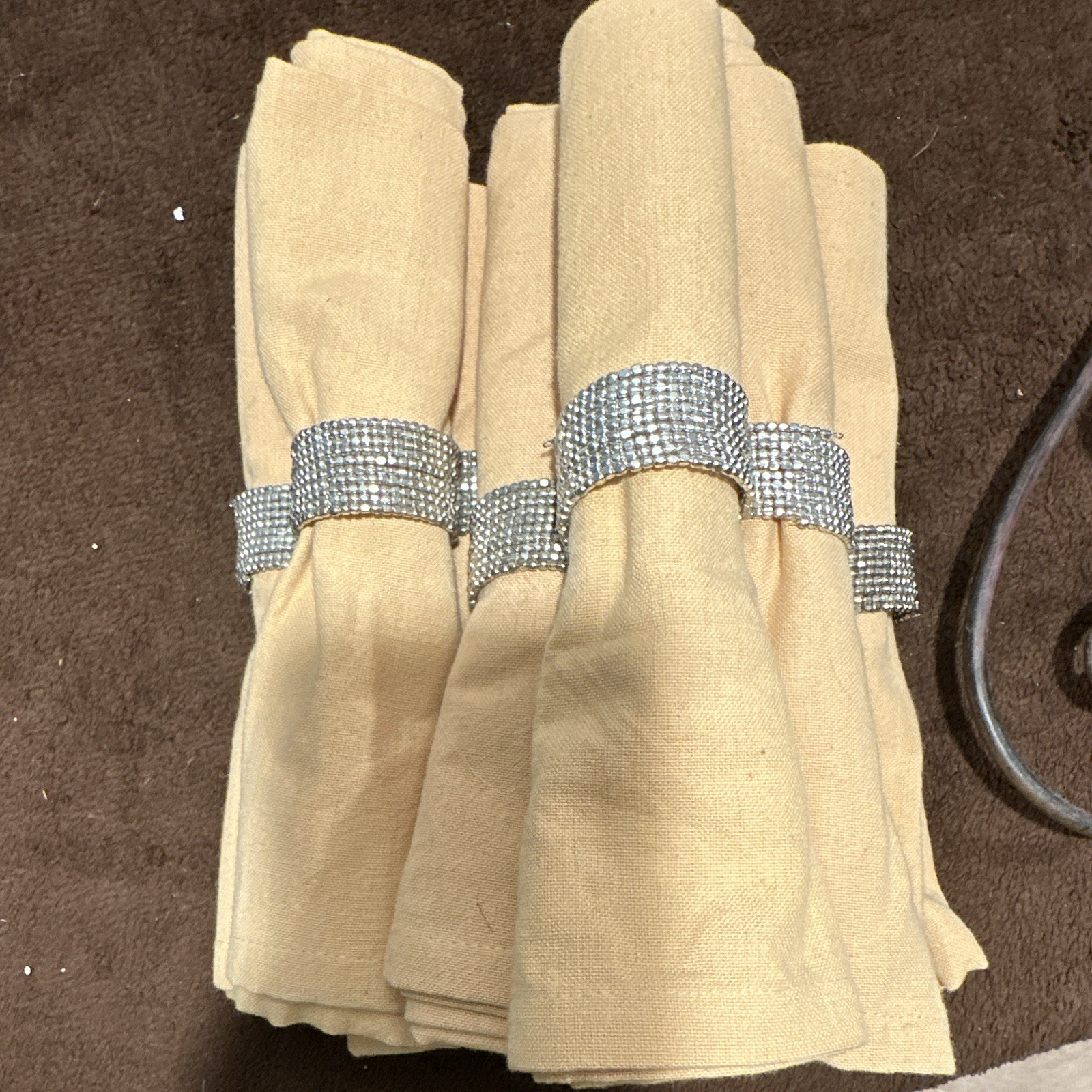 8 Silver Rhinestone Beaded Napkin Rings and yellow fabric napkins